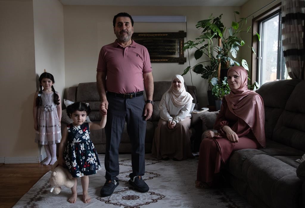 From left, Selena Moushli, 6, Mila Moushli, 2, Mahmoud Moushli, Ghena Moushli, 14, and Amani Shamseddin, pictured at their home in Edmonton, on Wednesday January 1, 2025.