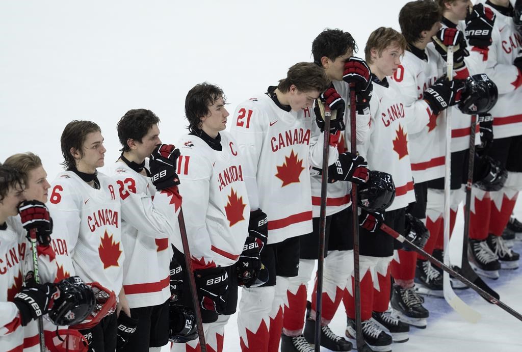 Canada captain Brayden Yager (11) stands on the blueline with teammates after losing 4-3 to Czechia in the IIHF World Junior Hockey Championship quarterfinal, in Ottawa, Thursday, Jan. 2, 2025.