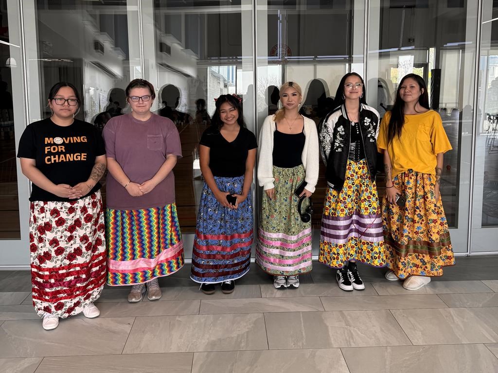 A group of Indigenous youth pose wearing the ribbon skirts they made with Growing Youth Movers at the mâmawêyatitân centre in Regina in this undated handout photo.