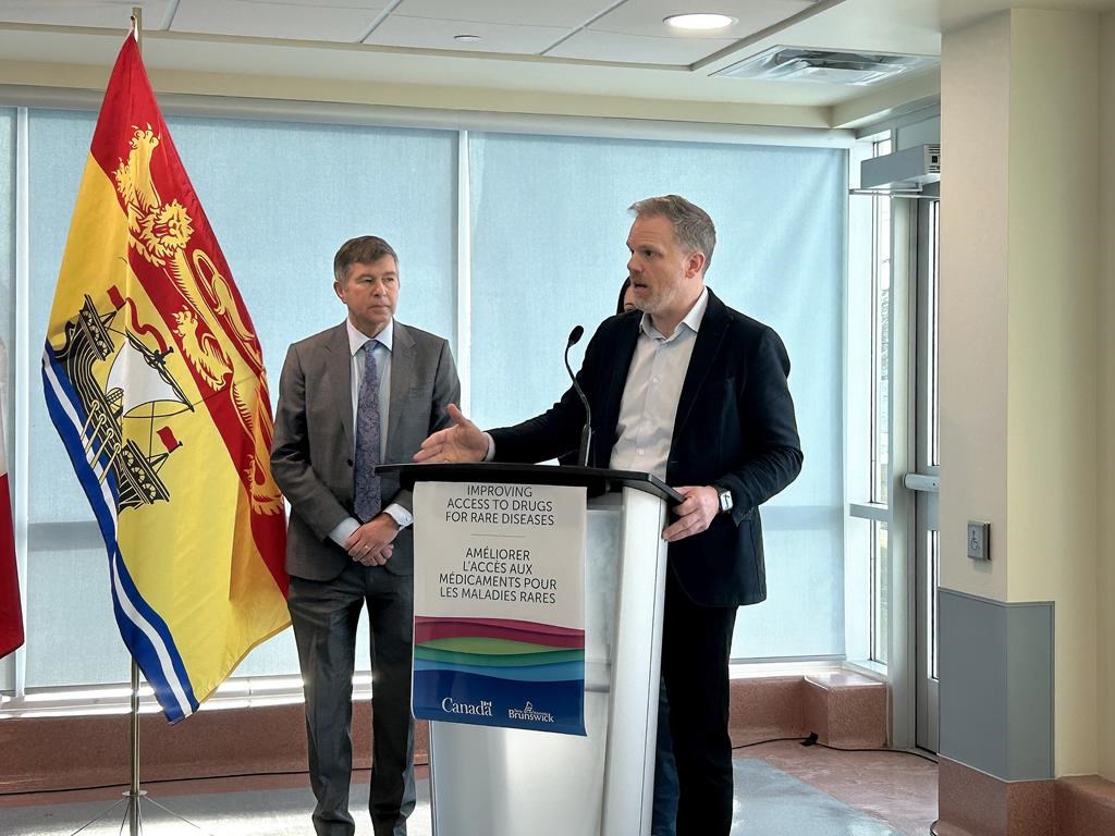 Federal Health Minister Mark Holland, right, speaks during a press conference as New Brunswick Health Minister John Dornan looks on at the Stan Cassidy Centre for Rehabilitation, in Fredericton, Wednesday. THE CANADIAN PRESS/Hina Alam.