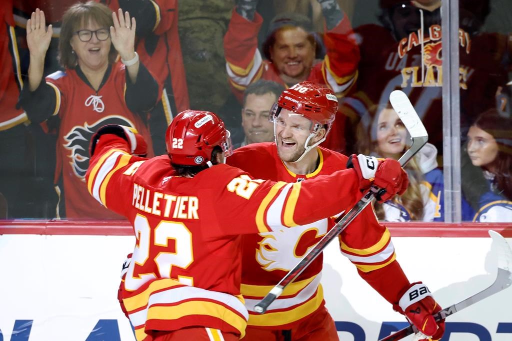 Calgary Flames' Jonathan Huberdeau, right, celebrates his goal against the Buffalo Sabres with Jakob Pelletier during first period NHL hockey action in Calgary on Thursday, Jan. 23, 2025.