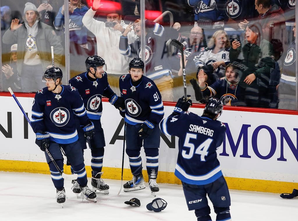 Winnipeg Jets' Vladislav Namestnikov (7), Nikolaj Ehlers (27), Cole Perfetti (91) and Dylan Samberg (54) celebrate Perfetti's hat-trick against the Utah Hockey Club during third period NHL action in Winnipeg on Friday, Jan. 24, 2025.