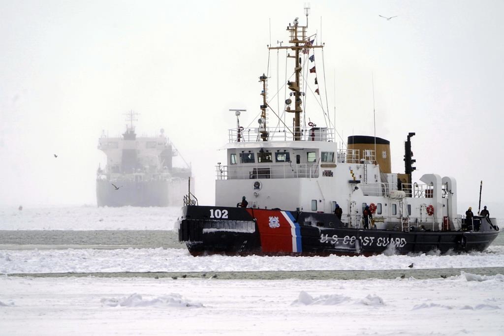 The U.S. Coast Guard Cutter Bristol Bay heads into Buffalo Harbor after spending the day breaking ice, Friday, Jan. 24, 2025, on Lake Erie around the lake freighter Manitoulin, which has been immobilized by thick lake ice since departing Buffalo on Wednesday morning, Jan. 22. (Derek Gee/The Buffalo News via AP).