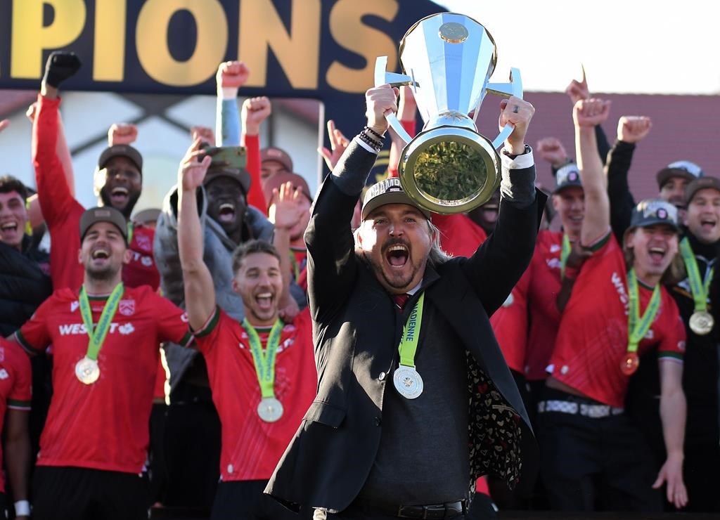 Cavalry FC head coach Tommy Wheeldon Jr. lifts the North Star Cup after Cavalry FC defeated Forge FC in the Canadian Premier League Final in Calgary, Saturday, November 9, 2024.