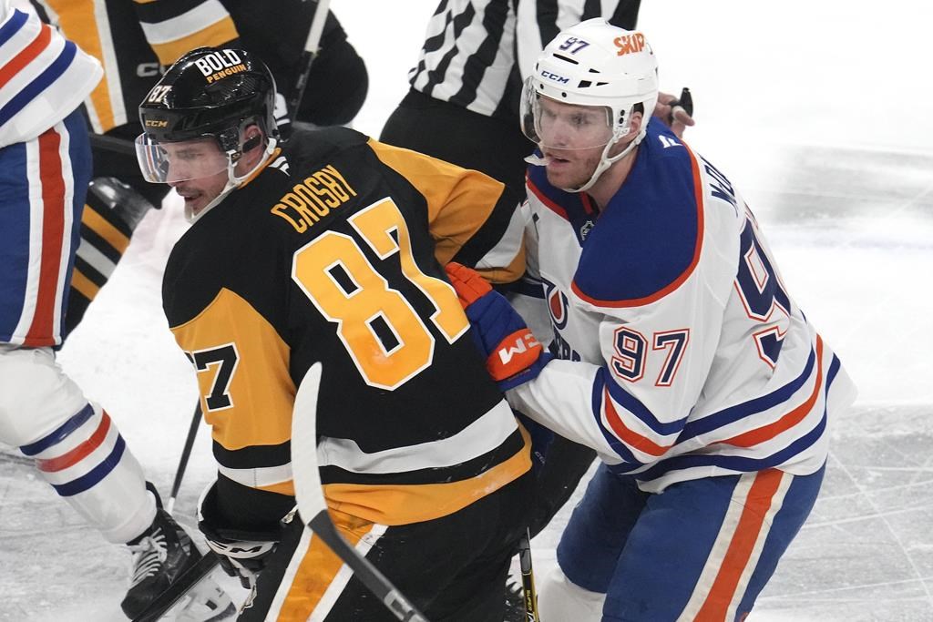 Pittsburgh Penguins' Sidney Crosby (87) and Edmonton Oilers' Connor McDavid (97) compete during NHL action in Pittsburgh, Thursday, Jan. 9, 2025.