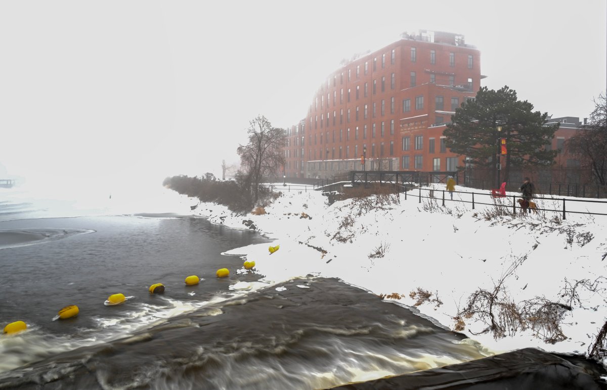 Water flows from a lock on the Lachine Canal next to the old Redpath Sugar Mill in Montreal, Sunday, December 29, 2024. Work on the canal began in 1821 and officially opened in 1825.