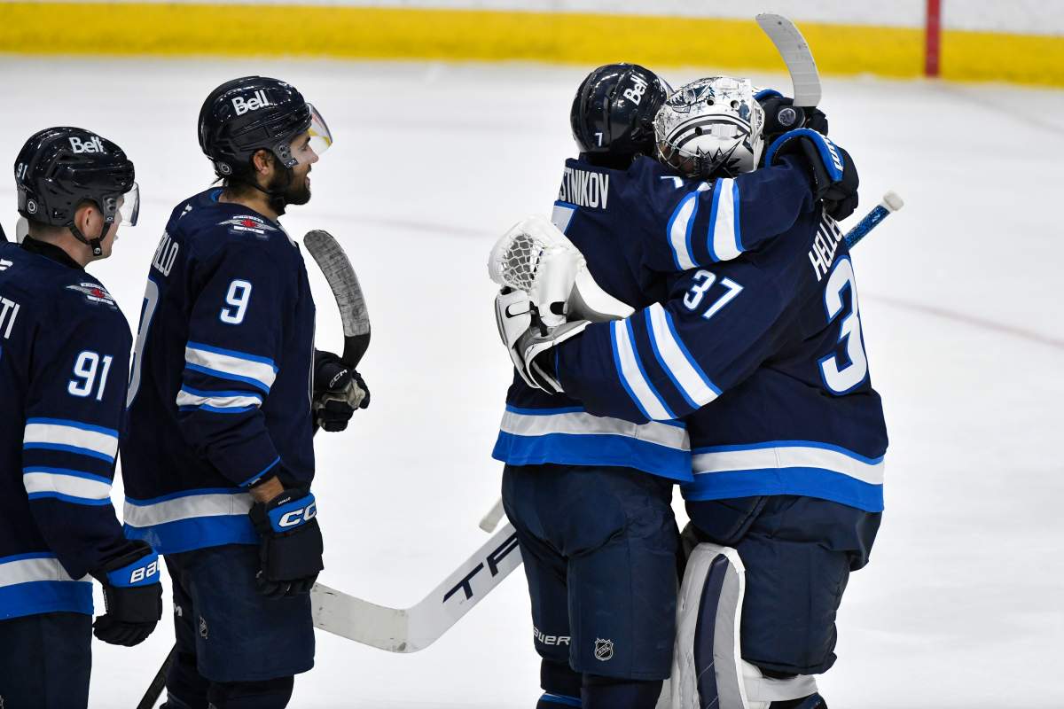 Winnipeg Jets goaltender Connor Hellebuyck (37) celebrates his 300th NHL win with Vladislav Namestnikov (7) following the team's win over the Nashville Predators in NHL hockey action, in Winnipeg, Tuesday, Jan. 7, 2025. 