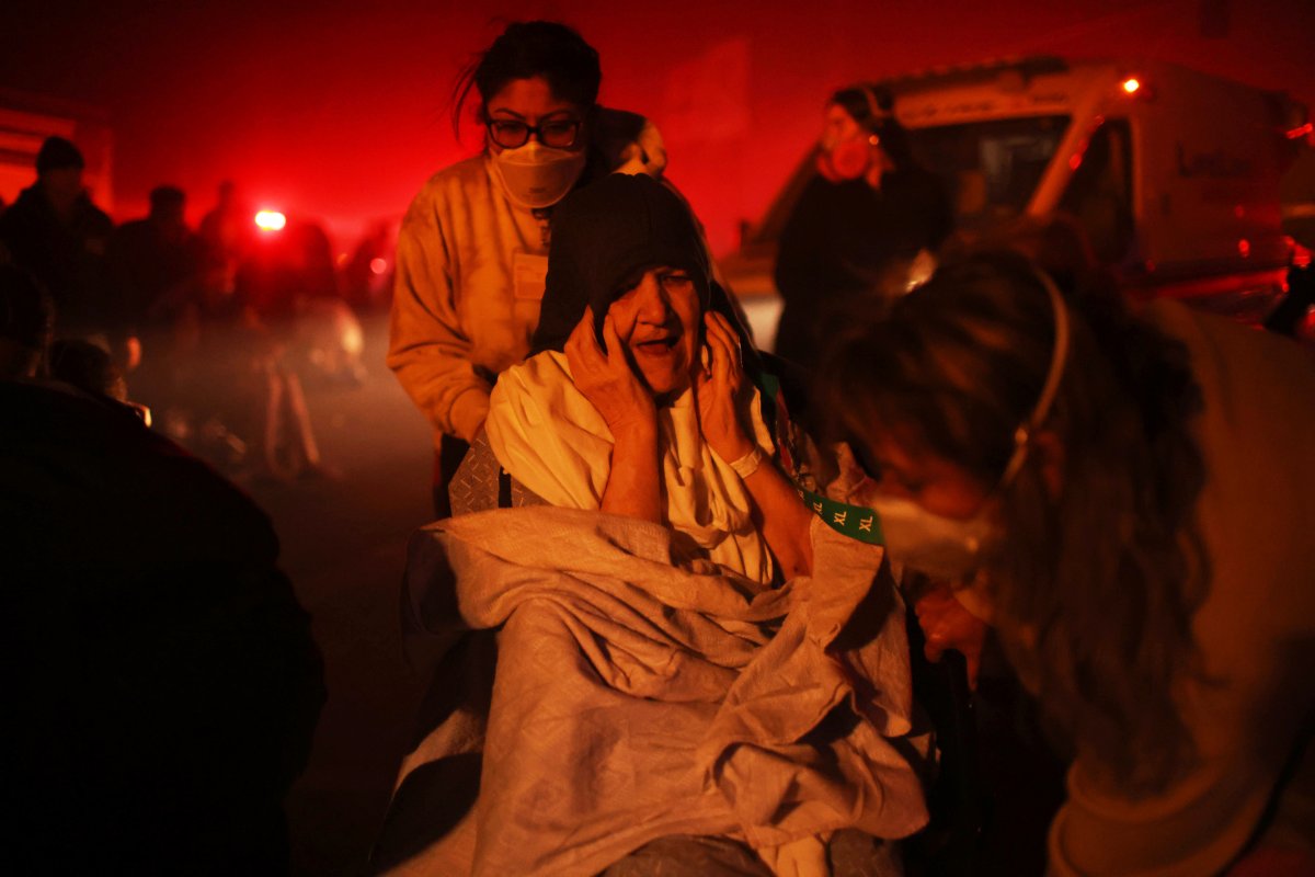 A resident of a senior center is evacuated as the Eaton Fire approaches Tuesday, Jan. 7, 2025 in Altadena, Calif.