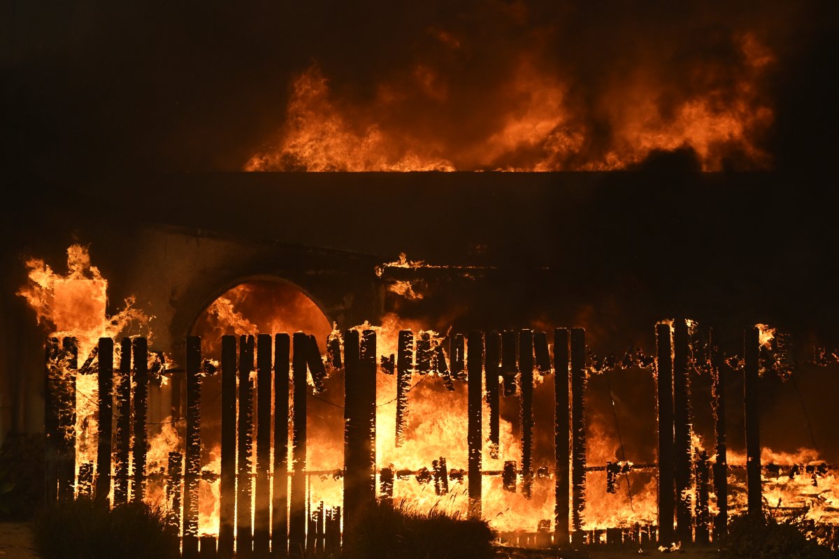 The Eaton Fire burns a structure Wed., Jan. 8, 2025 in Altadena, Calif.