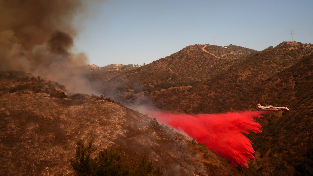 Retardant is dropped by air tanker on the Palisades Fire in Mandeville Canyon Saturday, Jan. 11, 2025, in Los Angeles.