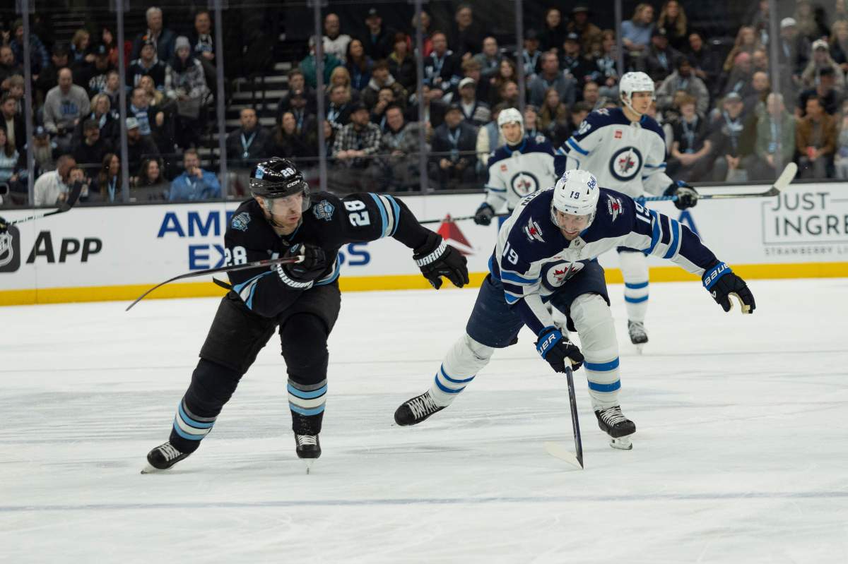 Utah Hockey Club defenseman Ian Cole (28) skates against Winnipeg Jets center David Gustafsson (19) during the second period of an NHL hockey game Monday, Jan. 20, 2025, in Salt Lake City. (AP Photo/Melissa Majchrzak).