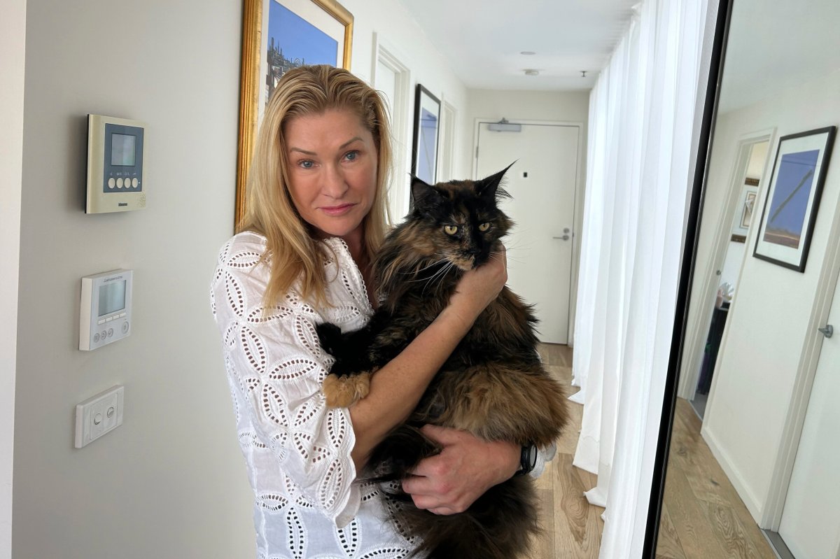 Margo Neas holds her cat Mittens at her home in Melbourne, Australia, on Wednesday, Jan. 22, 2025.