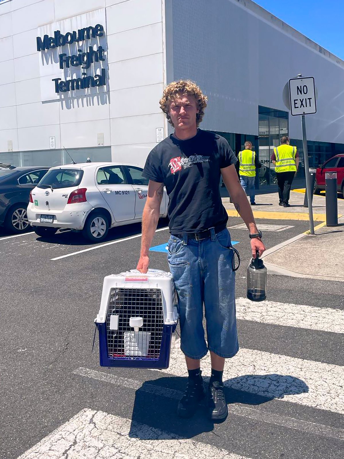 In this photo provided by Margo Neas, her son Jackson Brow holds their cat, Mittens, in a cat carrier at Melbourne Airport on Jan. 14, 2025.