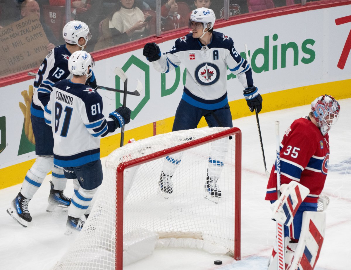 Winnipeg Jets' Mark Scheifele (55) celebrates his goal over Montreal Canadiens goaltender Sam Montembeault (35) with teammates Kyle Connor (81) and Gabriel Vilardi (13) during second period NHL hockey action in Montreal on Tuesday, Jan. 28, 2025. THE CANADIAN PRESS/Christinne Muschi.