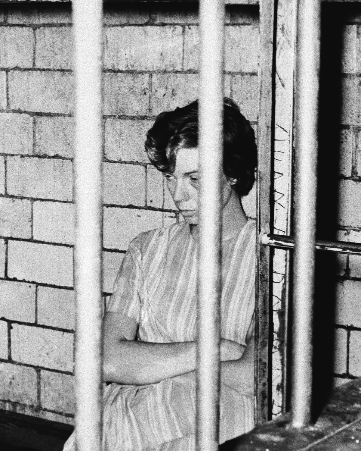 Sharon Kinne sits in her cell at police headquarters, Sept. 21, 1964, Mexico City, Mexico. She was being held in connection with Sept. 18 shooting of A Chicago man in local motel. Her left eye was blackened, although no explanation was given.