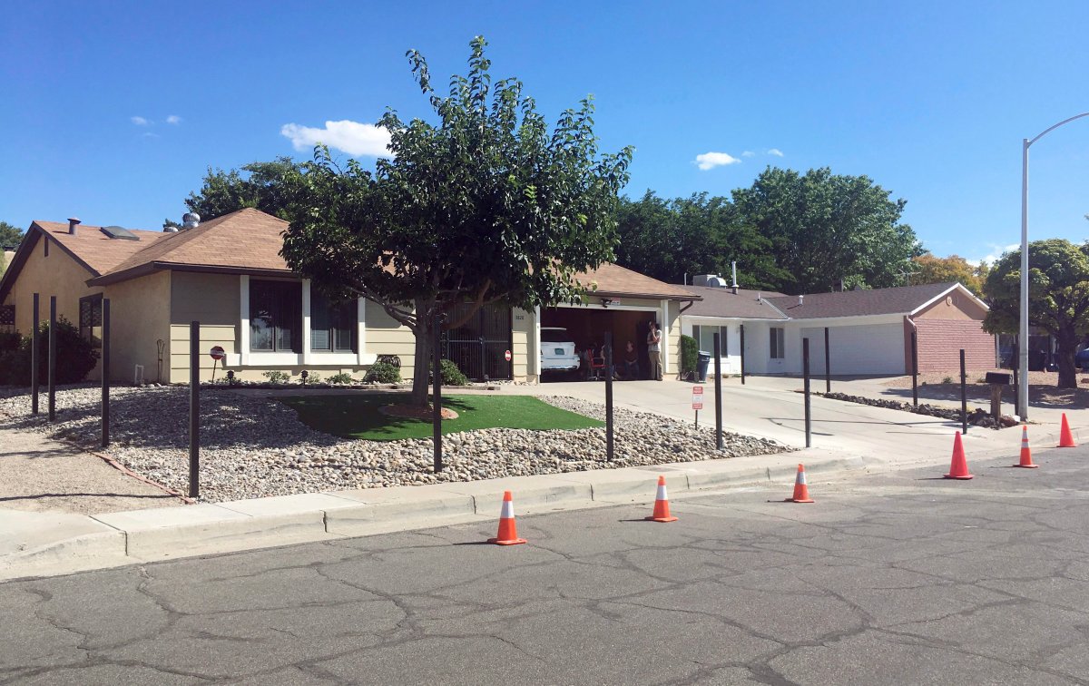 The house used in the AMC-TV series "Breaking Bad" with poles for a new fence is shown in this Friday, Oct. 13, 2017 photo in Albuquerque, N.M. The owners are erecting the fence around the real Albuquerque house made famous by the methamphetamine-making character Walter White, because the property has been plagued by countless fans wanting snapshots and selfies. (AP Photo/Russell Contreras)