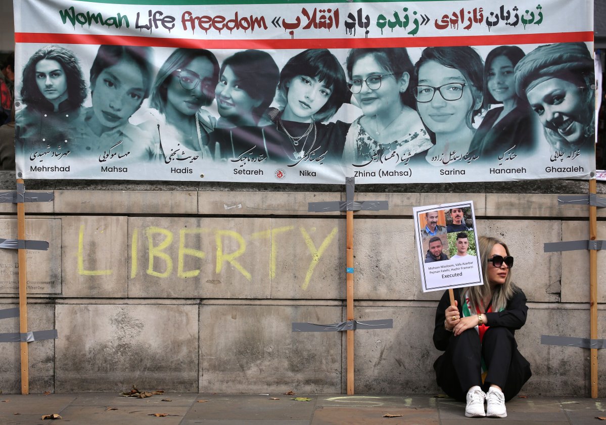 Protester holds sign showing the pictures of men executed men by Iran, on anniversary of the death of Mahsa Amini, Sept. 15, 2024, London, England. (Credit Image: © Martin Pope/ZUMA Press Wire)