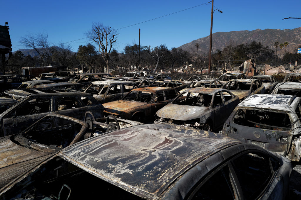 Cars destroyed by the Eaton Fire remain parked in a lot at the Altadena Auto Center on January 13, 2025 in Altadena, Calif.