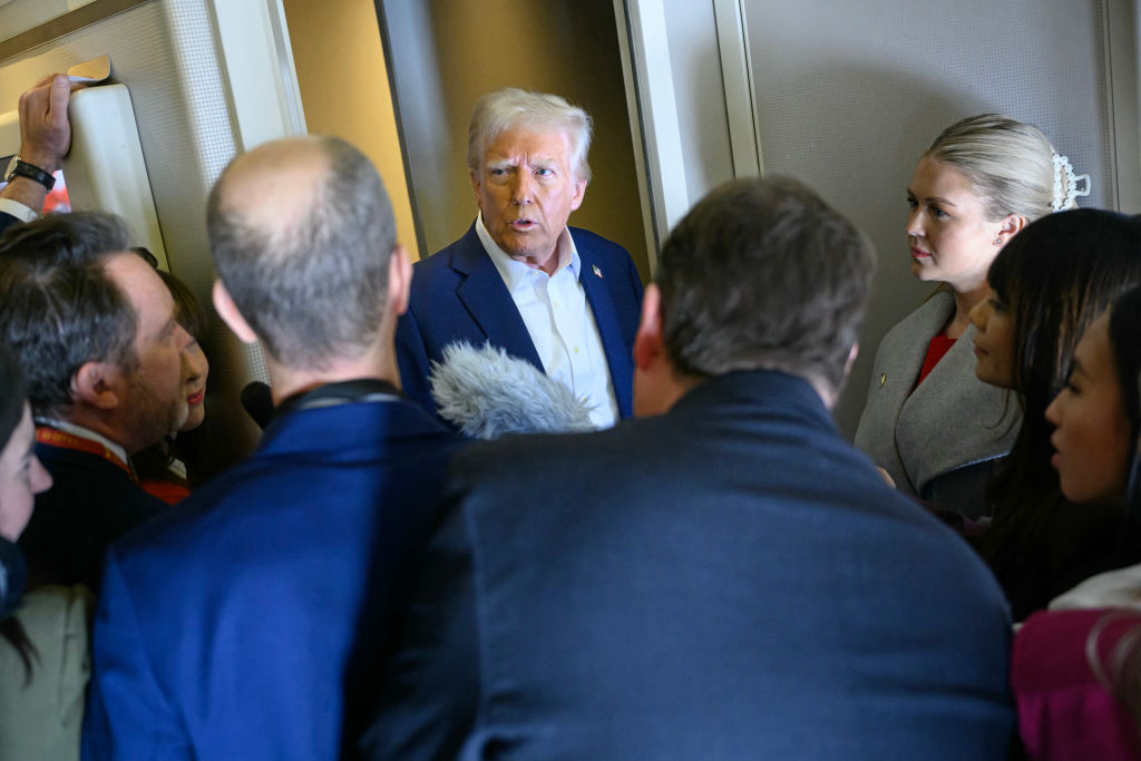 U.S. President Donald Trump speaks with the press, alongside White House Press Secretary Karoline Leavitt (R), on board Air Force One after departing Las Vegas, Nevada, en route to Miami, Florida on January 25, 2025.