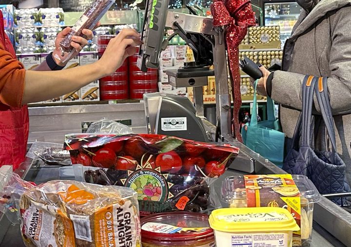 A file photo of a shopper checking out at a cash register in a grocery store in Wheeling, Ill.