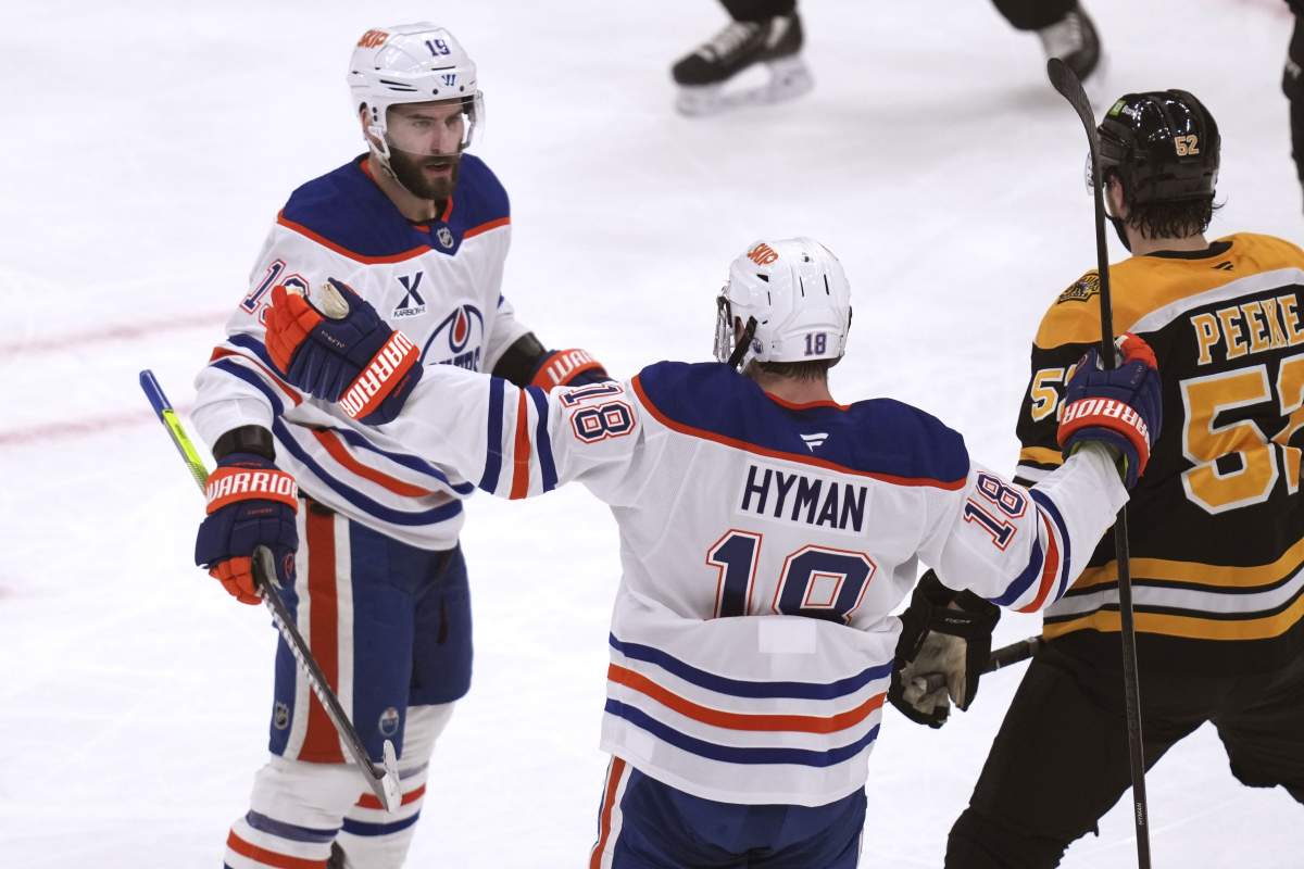 Edmonton Oilers centre Adam Henrique, left, is congratulated by Zach Hyman (18) after his goal agains the Boston Bruins during the second period of an NHL hockey game, Tuesday, Jan. 7, 2025, in Boston.