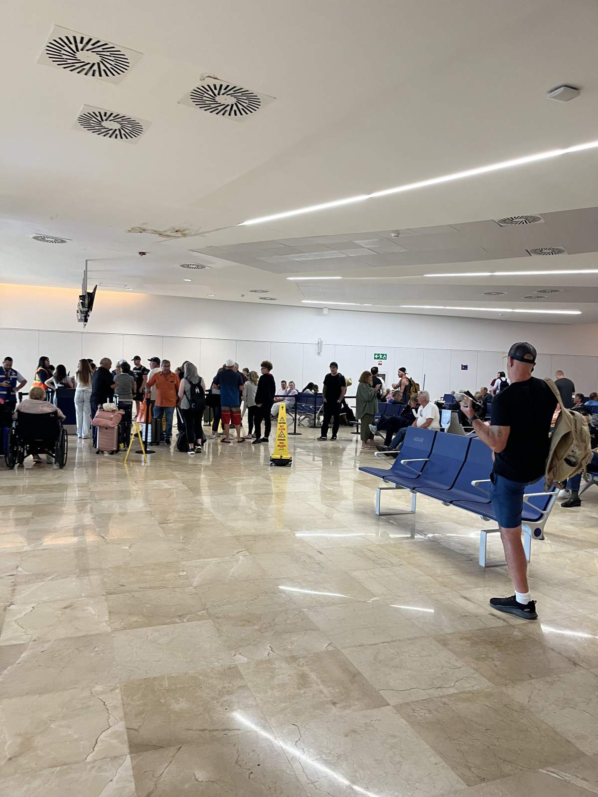 Hundreds of passengers wait in line at Cancun International Airport on Friday, Jan. 31. Passengers on the flight back to Calgary have faced 48 hours of delays.
