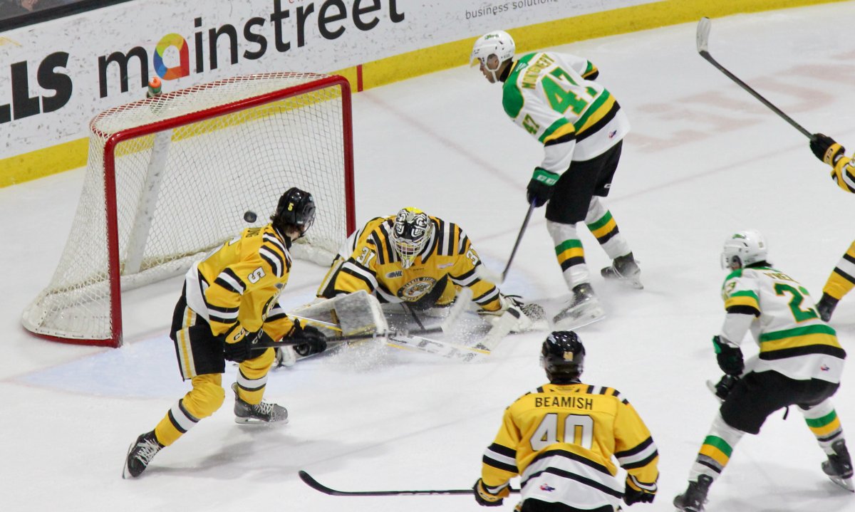 London Knights forward Blake Montgomery (47) gets a chance in tight on Sarnia Sting goalie Nick Surczycia in a game played between London and Sarnia on New Year's Day in 2025.