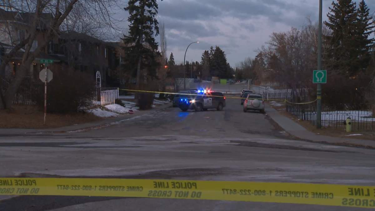 Police tape surrounds the corner of 39th St. SW and 15th Ave. SW in Calgary after a serious assault at a home on Friday, Jan. 24. 