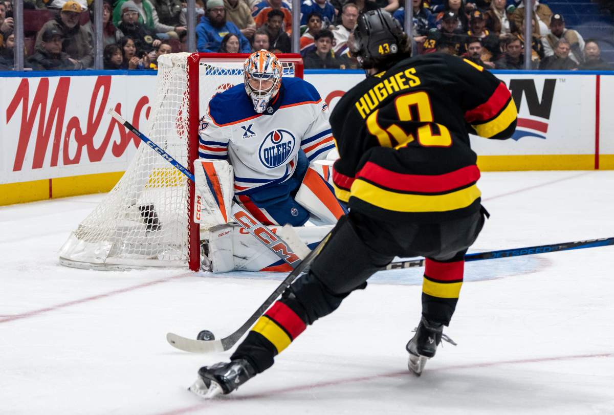 Vancouver Canucks' Quinn Hughes (43) prepares to shoot the puck as Edmonton Oilers goaltender Stuart Skinner (74) watches during the third period of an NHL hockey game in Vancouver, on Saturday, January 18, 2025.