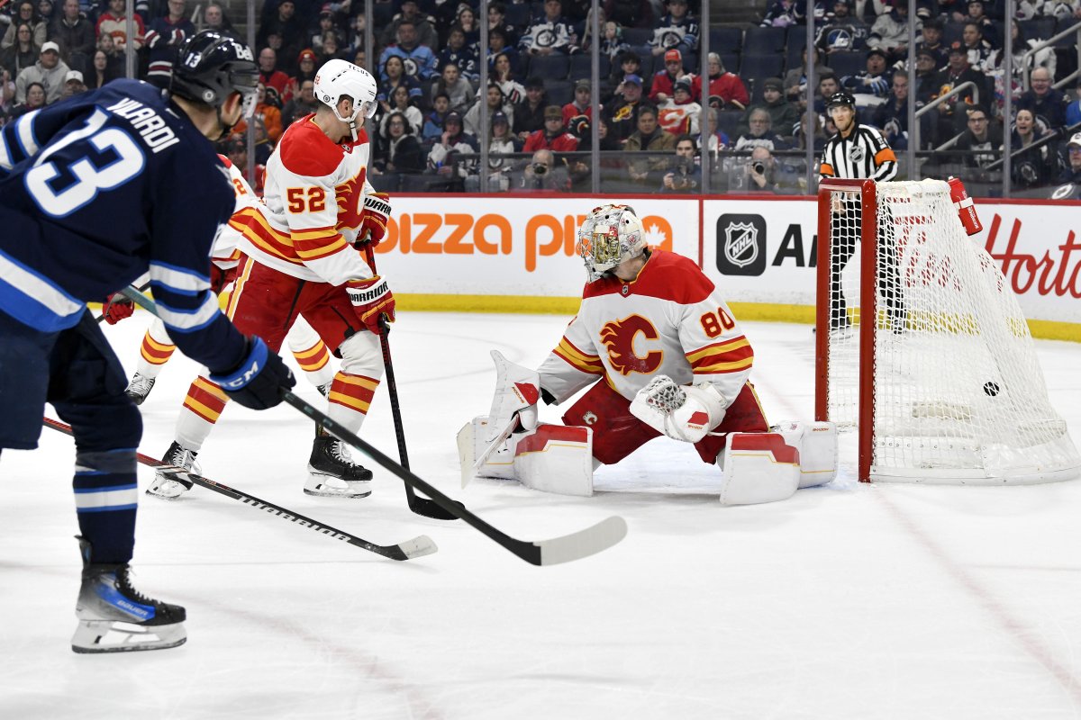 Winnipeg Jets' Gabriel Vilardi (13) scores on Calgary Flames goaltender Dan Vladar (80) during the second period of their NHL hockey game in Winnipeg, Sunday, Jan. 26, 2025.