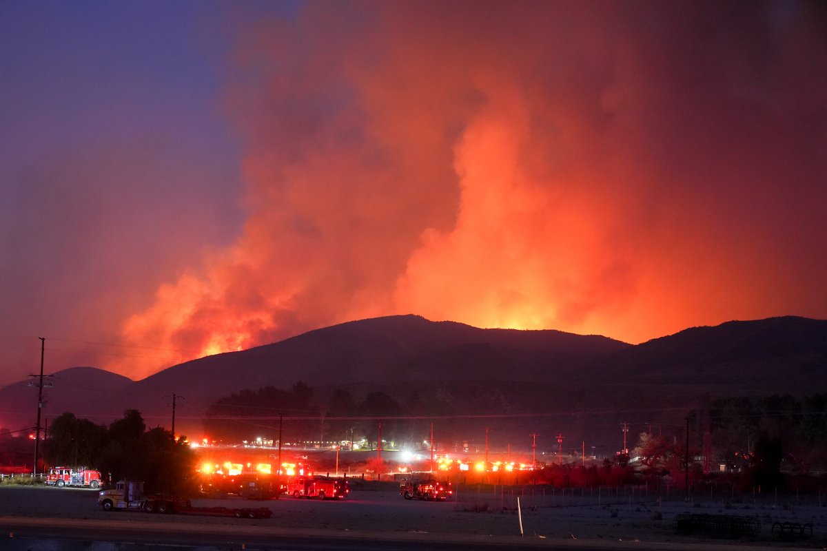 Fire Crews stage under the Hughes Fire Wednesday, Jan. 22, 2025, in Castaic, Calif.