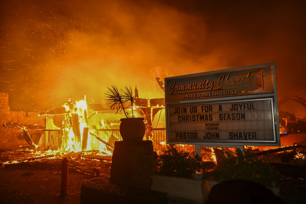 A house in on fire as residents try to escape the site in Pacific Palisades, California, Los Angeles, United States on January 8, 2025.