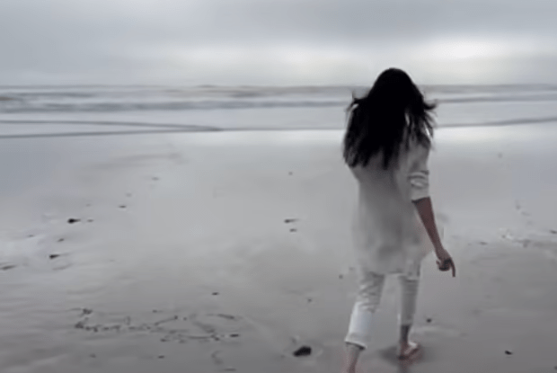 As Meghan Markle jogs toward the ocean, a previous "2025" can be seen already written in the sand.