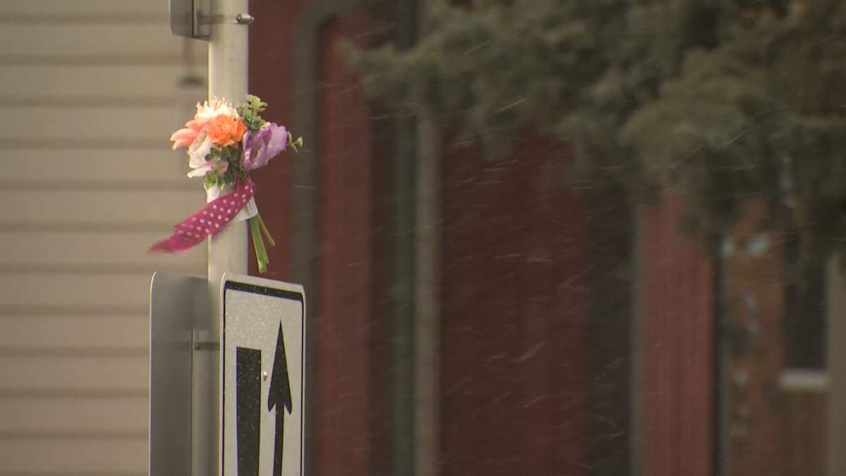 A bouquet of flowers fastened to a pole at the intersection in the Calgary neighbourhood of Pineridge where a 17-year-old female pedestrian was killed when she was struck by a car on Wed. Jan. 16, 2025.