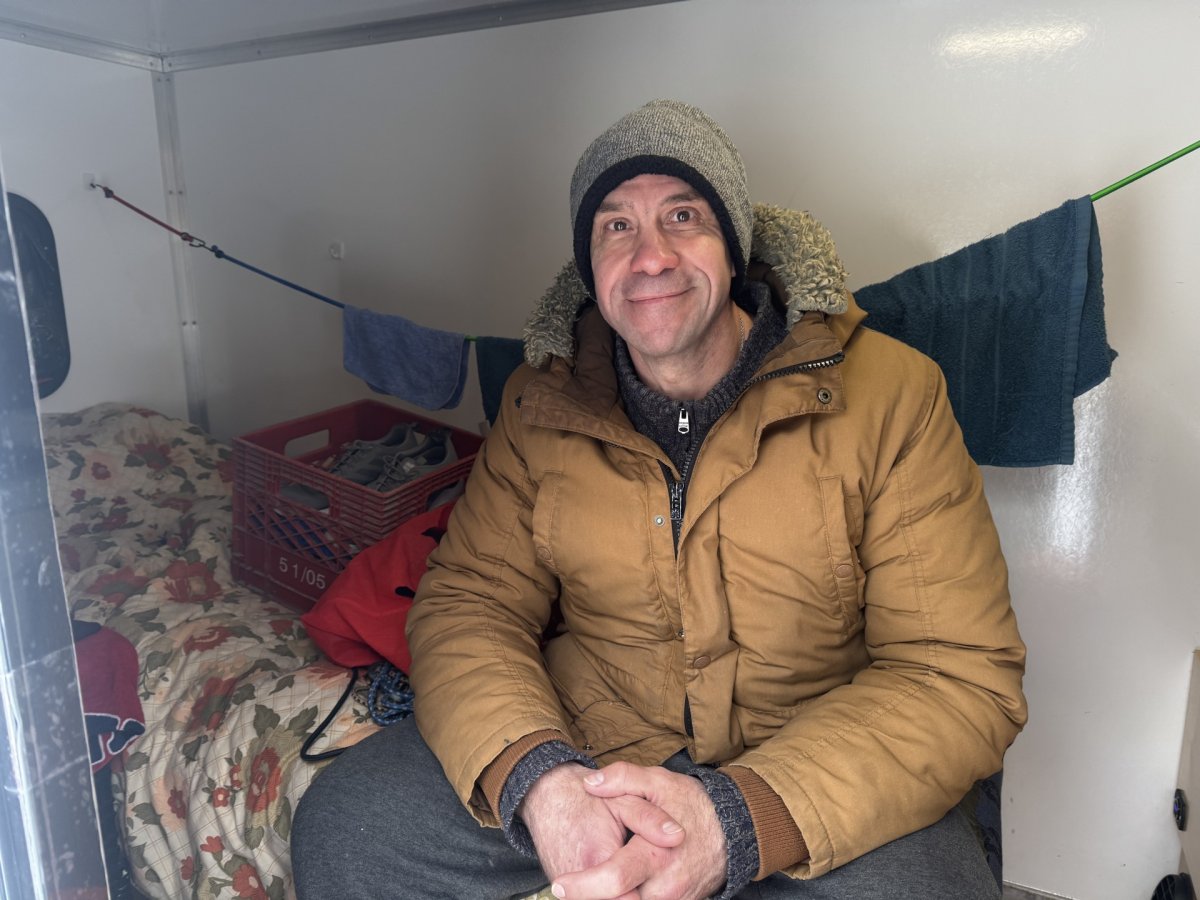 Tiny home resident, Nauel Samu, inside his unit provided by Tiny Tiny Homes.