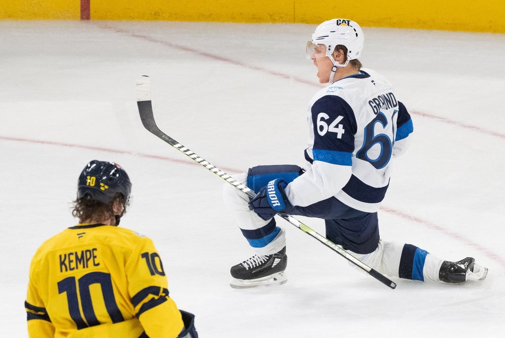Finland's Mikael Granlund (64) celebrates his winning goal as Sweden's Adrian Kempe (10) looks on during 4 Nations Face-Off overtime hockey action in Montreal on Saturday, Feb. 15, 2025.
