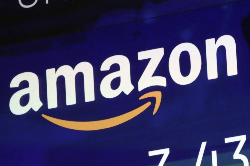 FILE - The logo for Amazon.com Inc. is displayed on a screen at the Nasdaq MarketSite, July 27, 2018. (AP Photo/Richard Drew, File).