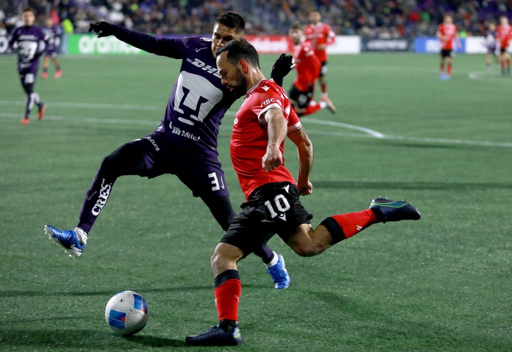 Cavalry FC's Sergio Camargo attempts a shot on net as Pumas UNAM's Ricardo Galindo tries to steal the ball way during first half soccer action in round one of the 2025 CONCACAF Champions Cup in Langford, B.C., on Thursday, February 6, 2025.