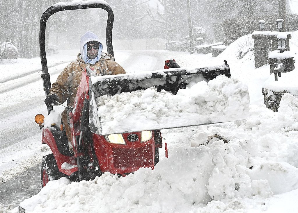 Matt Hodges plows snow from his driveway in Beckley, W.Va., Tuesday, Feb. 11, 2025.