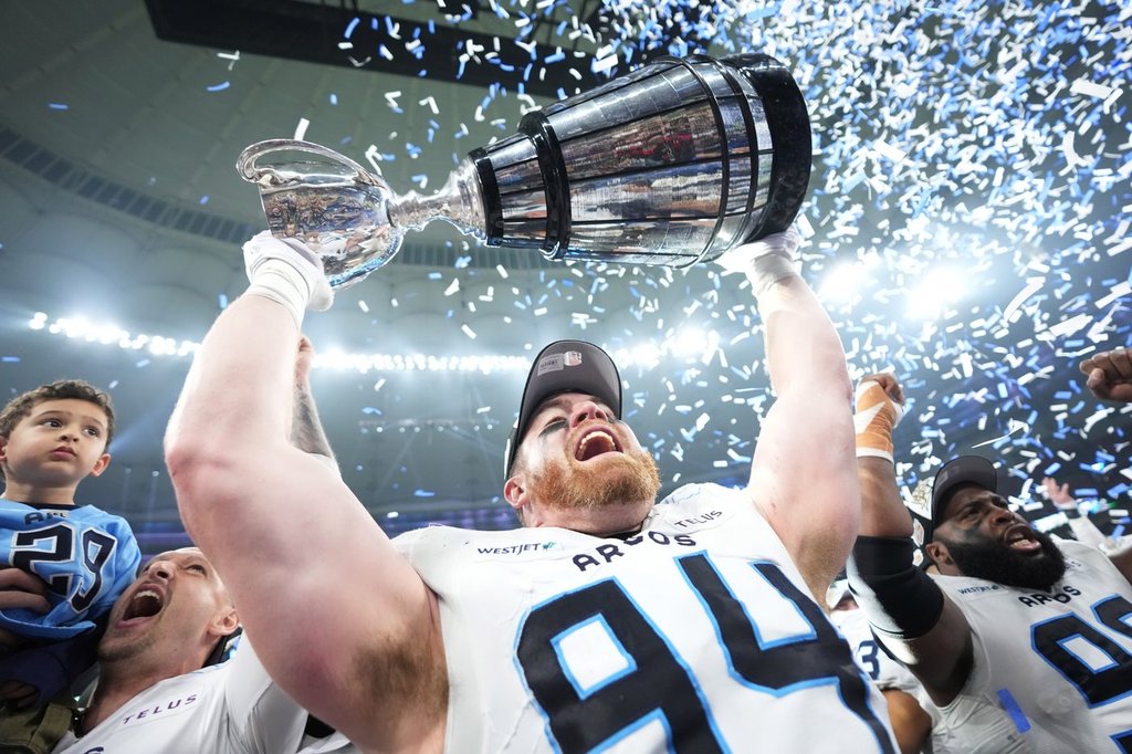 Toronto Argonauts' Jake Ceresna (94) lifts the Grey Cup after defeating the Winnipeg Blue Bombers in CFL football action at the 111th Grey Cup in Vancouver on Nov. 17, 2024. THE CANADIAN PRESS/Nathan Denette.