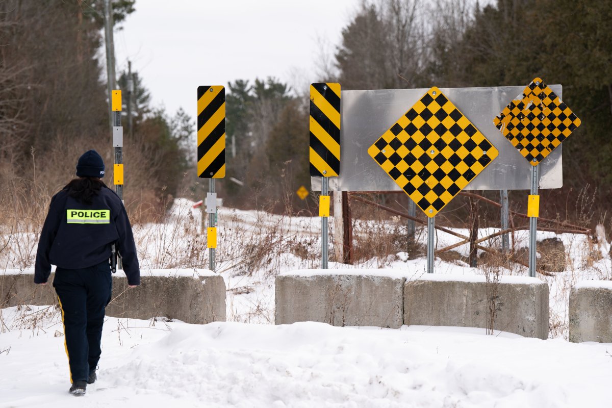 The Canada Border Services Agency says it’s looking to open a processing centre for asylum seekers near the U.S. border in Quebec as a contingency plan in case of an “influx” of claimants. An RCMP officer checks the border between Quebec and New York State on Roxham Road in St. Bernard-de-Lacolle, Que. on Wednesday, Jan.15, 2025.