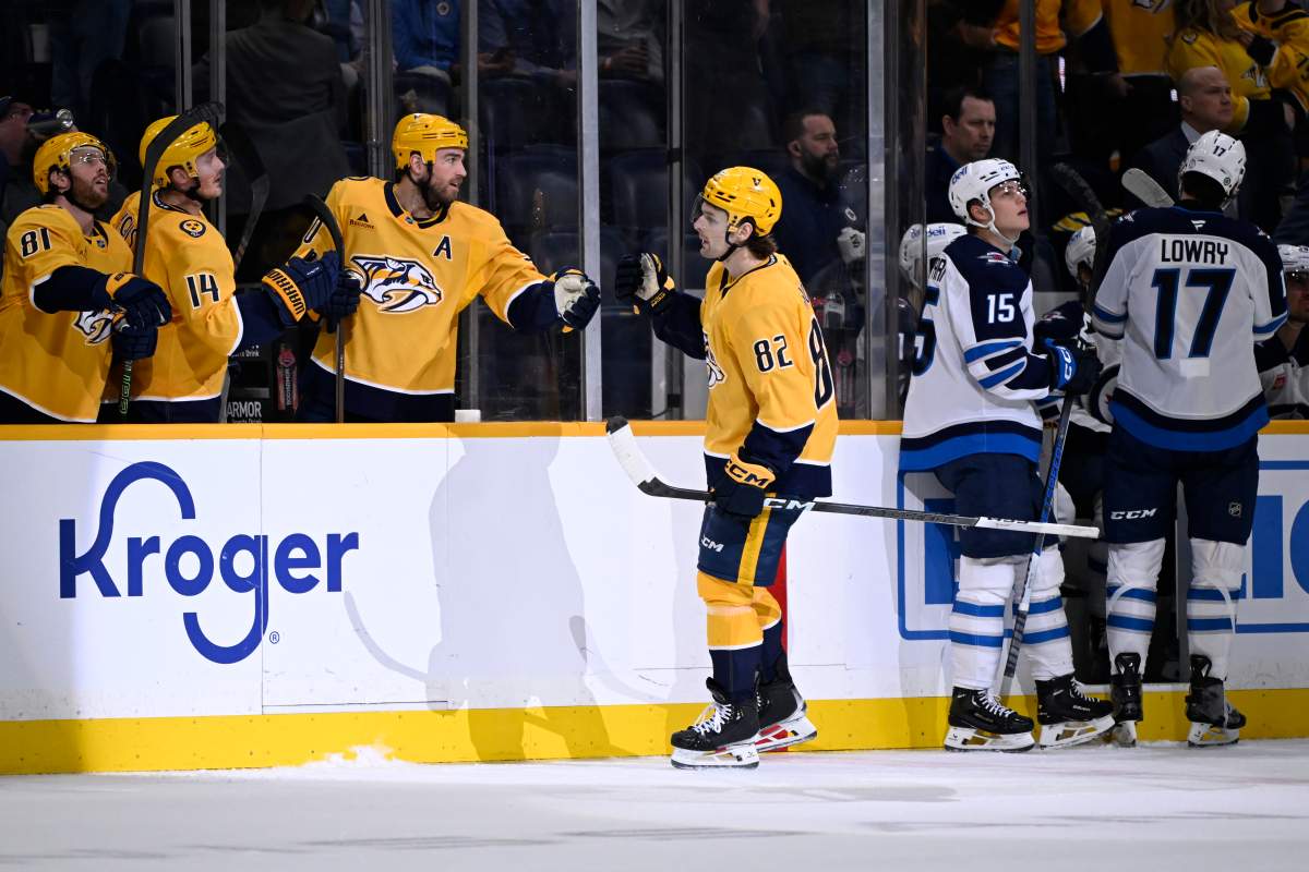 Nashville Predators center Tommy Novak (82) is congratulated for his goal against the Winnipeg Jets during the first period of an NHL hockey game Thursday, Feb. 27, 2025, in Nashville, Tenn. (AP Photo/John Amis).
