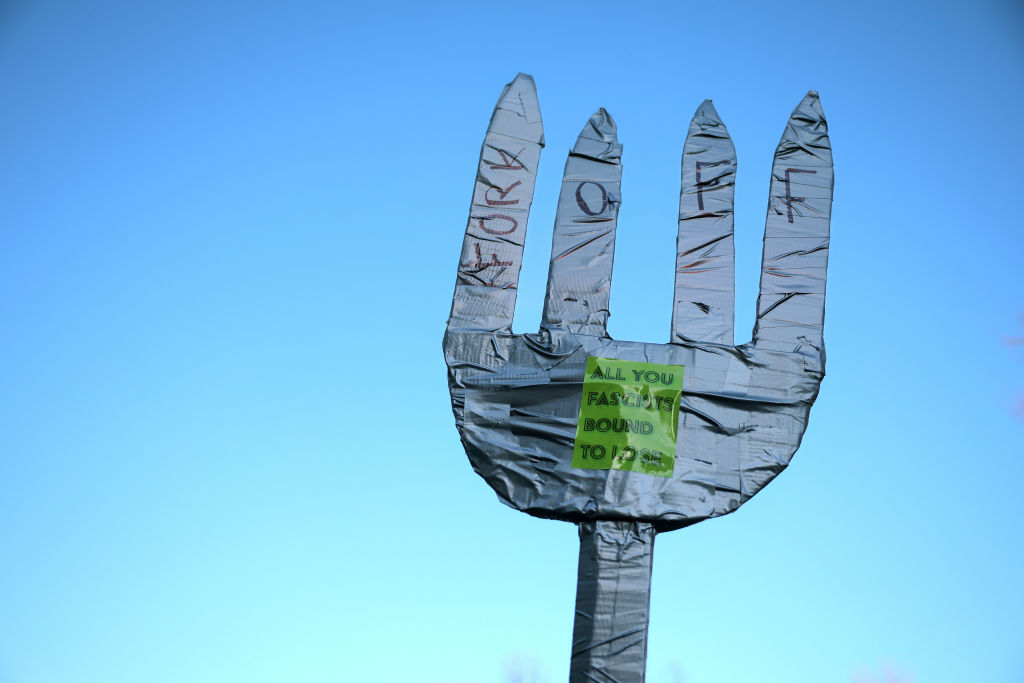 An oversized fork is seen at a rally with federal workers and supporters as they protest against Elon Musk and his Department of Government Efficiency (DOGE) outside of the Office of Personnel Management (OPM) headquarters on Feb. 07, 2025 in Washington, D.C.