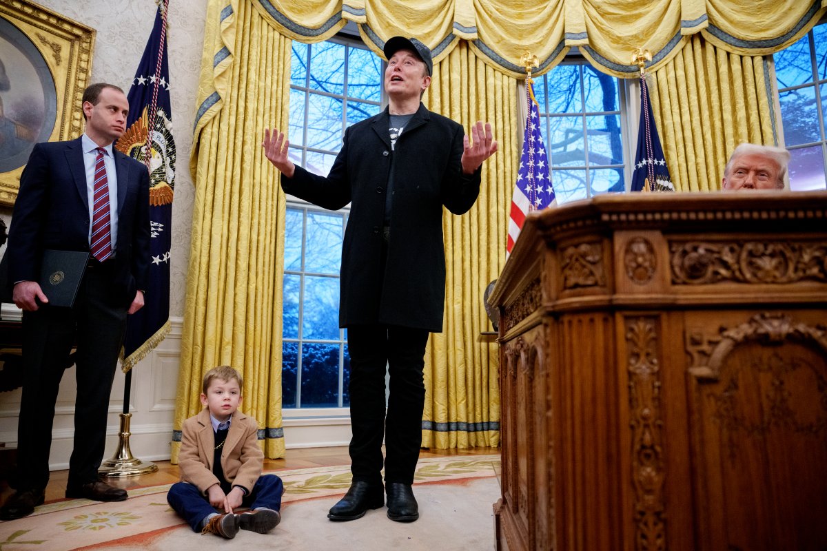 Tesla and SpaceX CEO Elon Musk, accompanied by U.S. President Donald Trump (R), his son X Musk, and White House staff secretary Will Scharf (L), speaks during an executive order signing in the Oval Office at the White House on February 11, 2025 in Washington, DC.