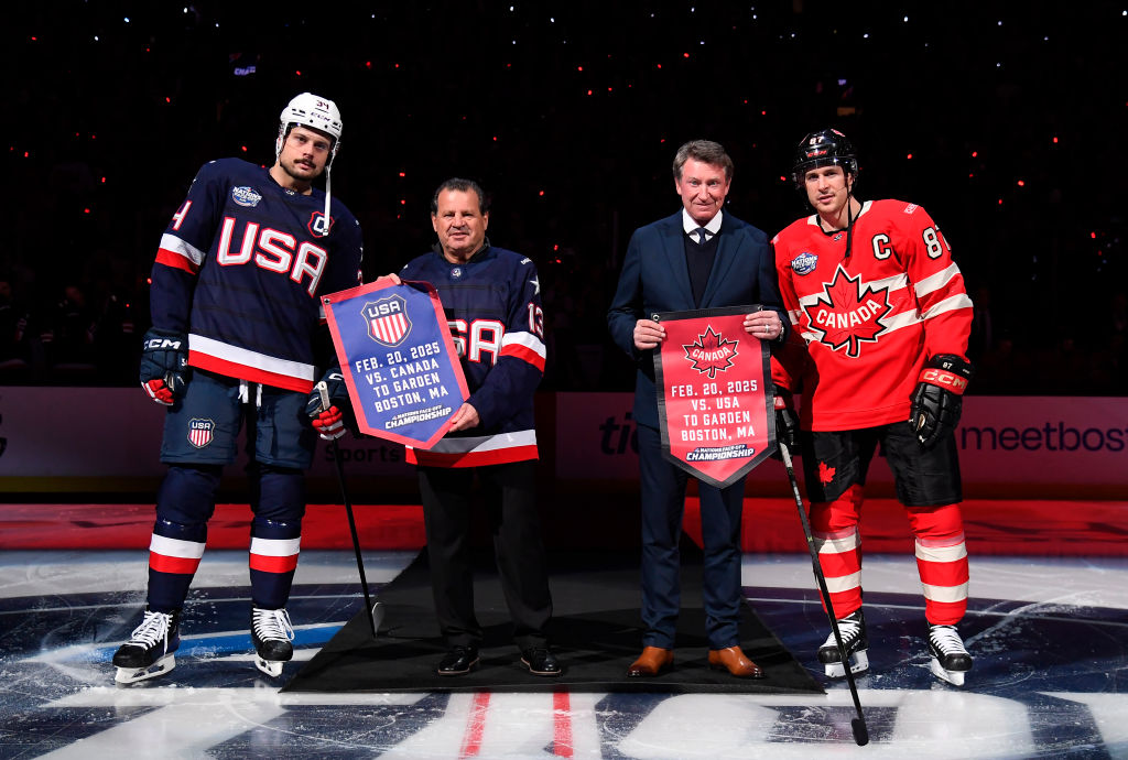 (L-R) Auston Matthews #34 of Team United States, honorary captains Mike Eruzione of Team United States and Wayne Gretzky of Team Canada and Sidney Crosby #87 of Team Canada pose for a photo at center ice during pre-game ceremonies before the 4 Nations Face-Off Championship game between Team Canada and Team United States at TD Garden on February 20, 2025 in Boston, Massachusetts.