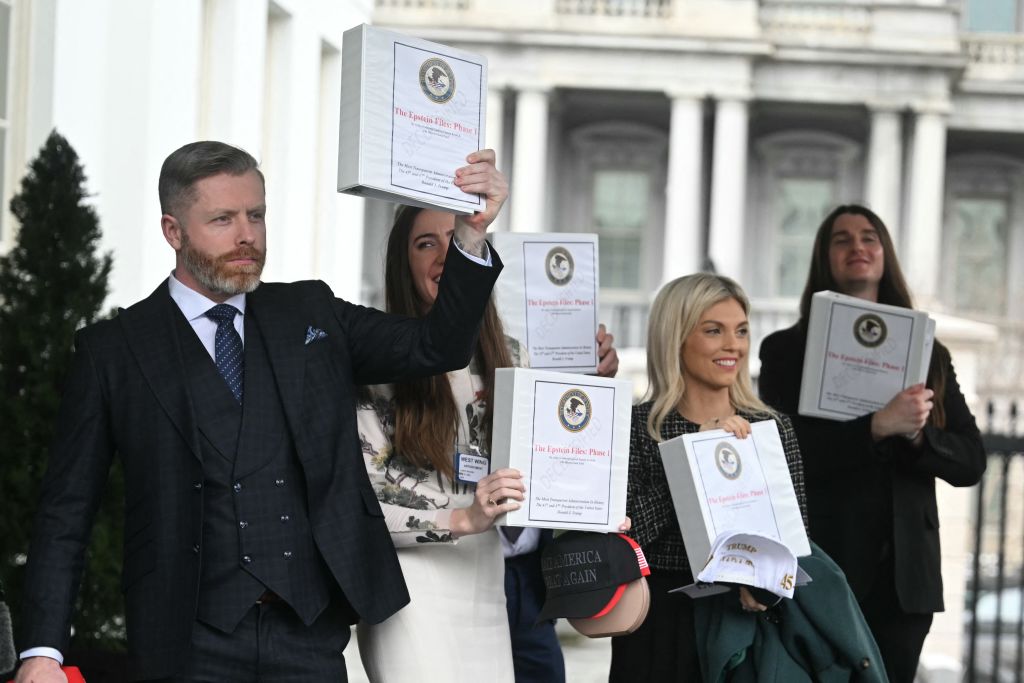 (From L) Political commentator Rogan O'Handley, aka DC Draino, TikToker Chaya Raichik, commentator Liz Wheeler and US conservative activist Scott Presler carry binders bearing the seal of the US Justice Department reading "The Epstein Files: Phase 1" as they walk out of the West Wing of the White House in Washington, DC, on February 27, 2025. The Trump administration has said it would release documents on late tycoon and convicted sex trafficker Jeffrey Epstein who was found dead in his prison cell in 2019.