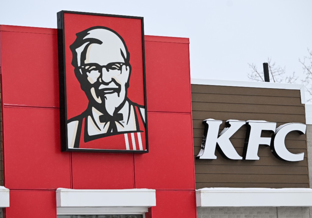 The KFC logo is displayed on the storefront of a KFC fast-food restaurant in Edmonton, Alberta, Canada, on February 15, 2025.