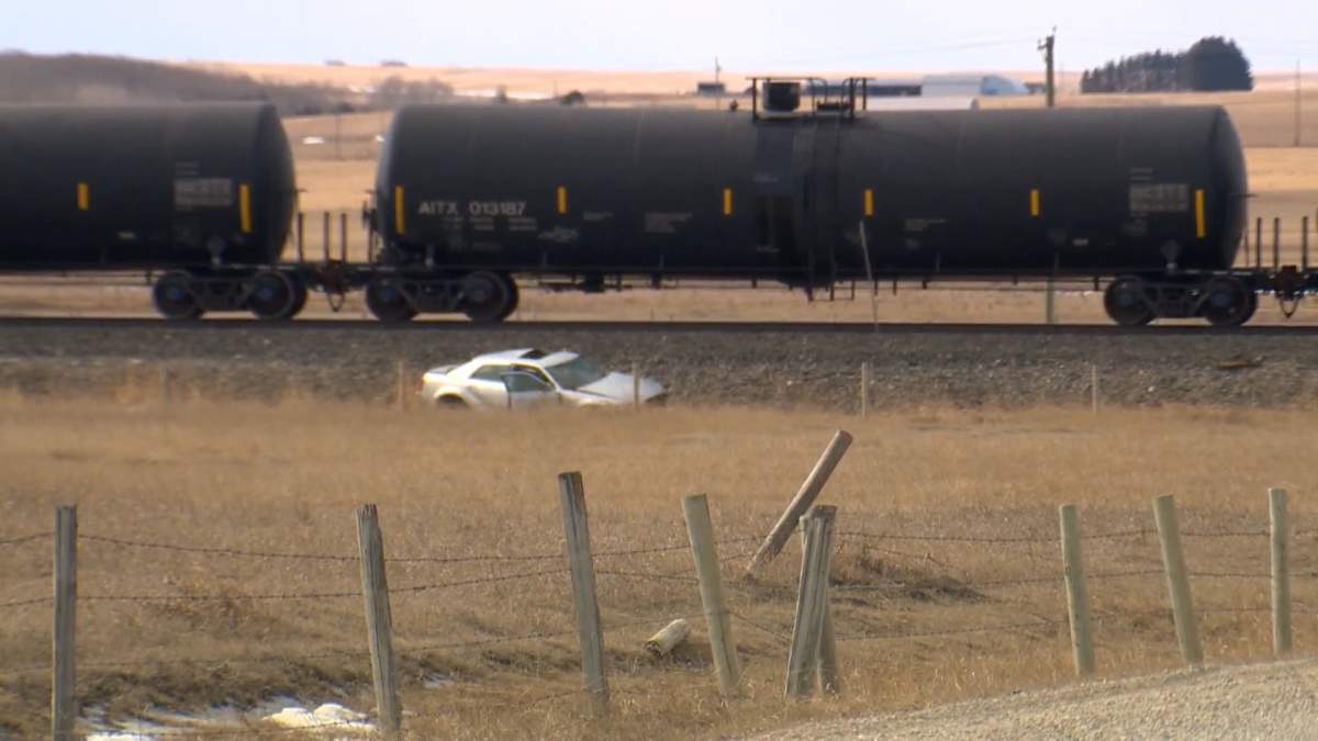 RCMP say a woman, who was the only person in the car, was killed when the vehicle collided with a train near Airdrie on Thursday.