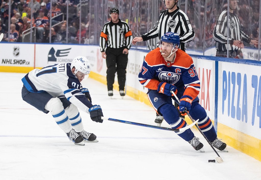 Winnipeg Jets' Cole Perfetti (91) chases Edmonton Oilers' Connor McDavid (97) during second-period NHL action in Edmonton on Thursday, March 20, 2025.