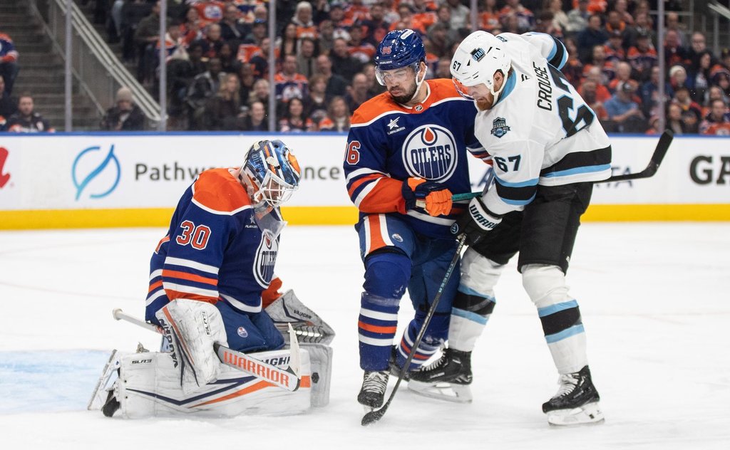 Utah Hockey Club's Lawson Crouse (67) is stopped by Edmonton Oilers' goalie Calvin Pickard (30) as Jake Walman (96) defends during third period NHL action in Edmonton on Tuesday, March 18, 2025.